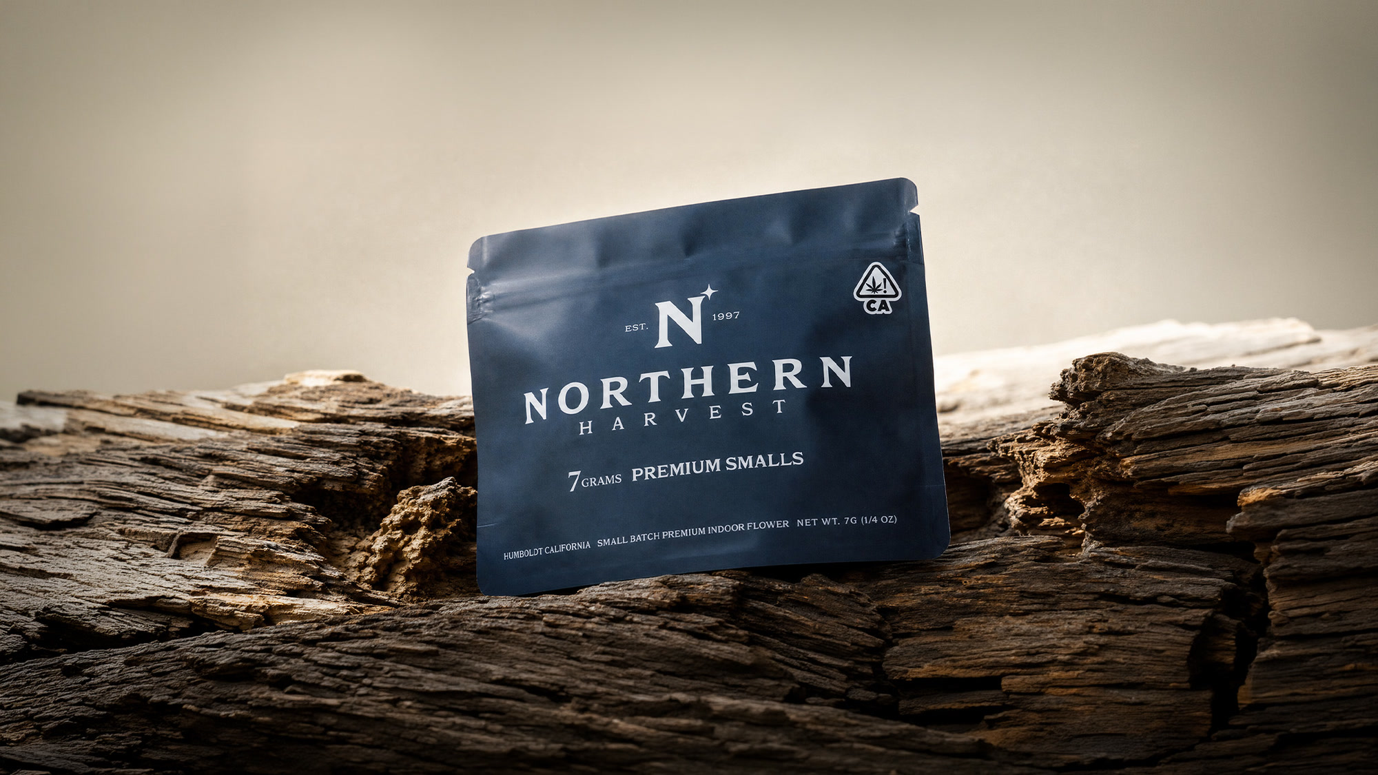 Northern Harvest 7g premium smalls mylar pouch resting on weathered driftwood in Humboldt, California